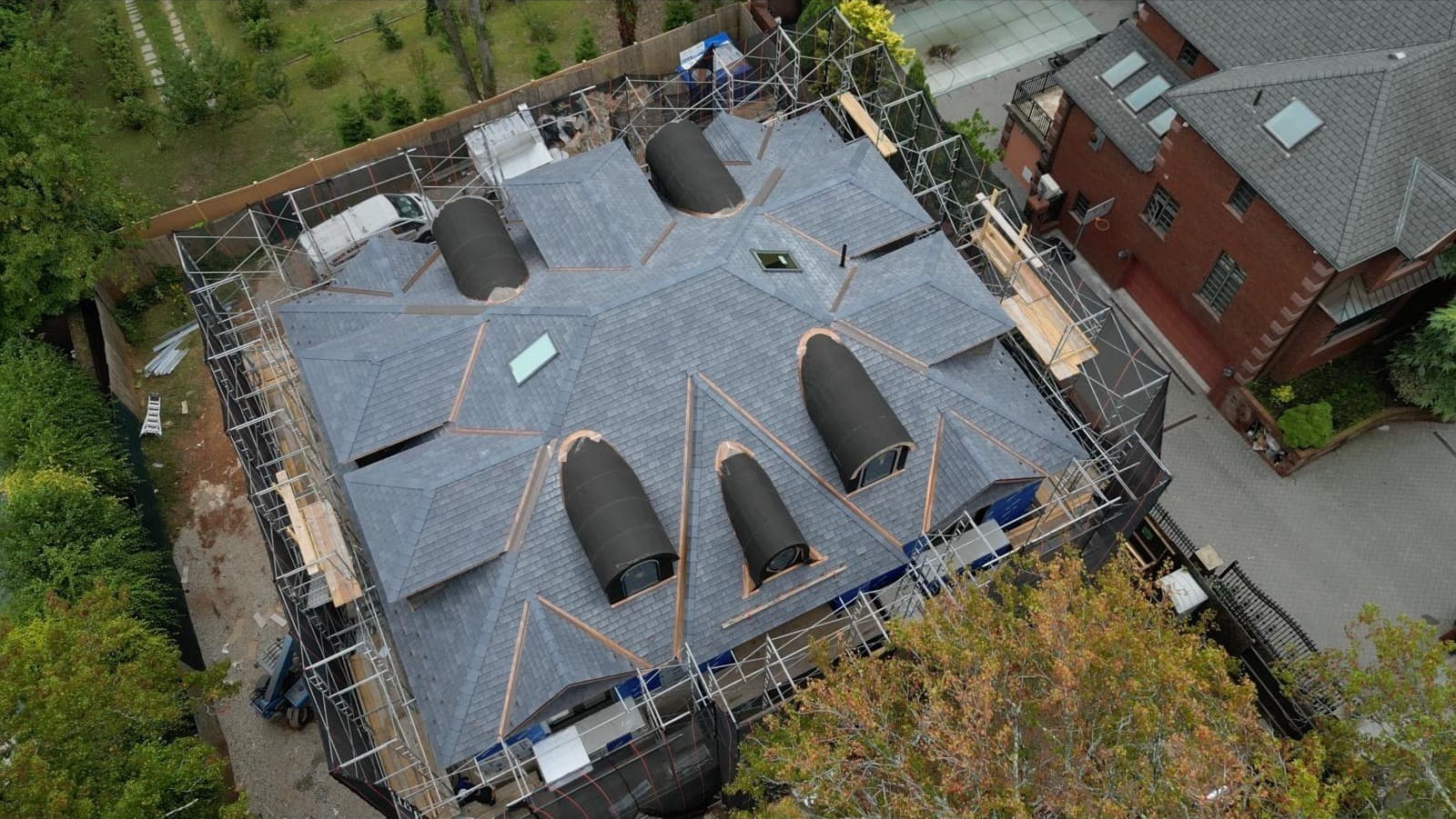 Luxury Slate Roof with Copper Barrel Dormers
